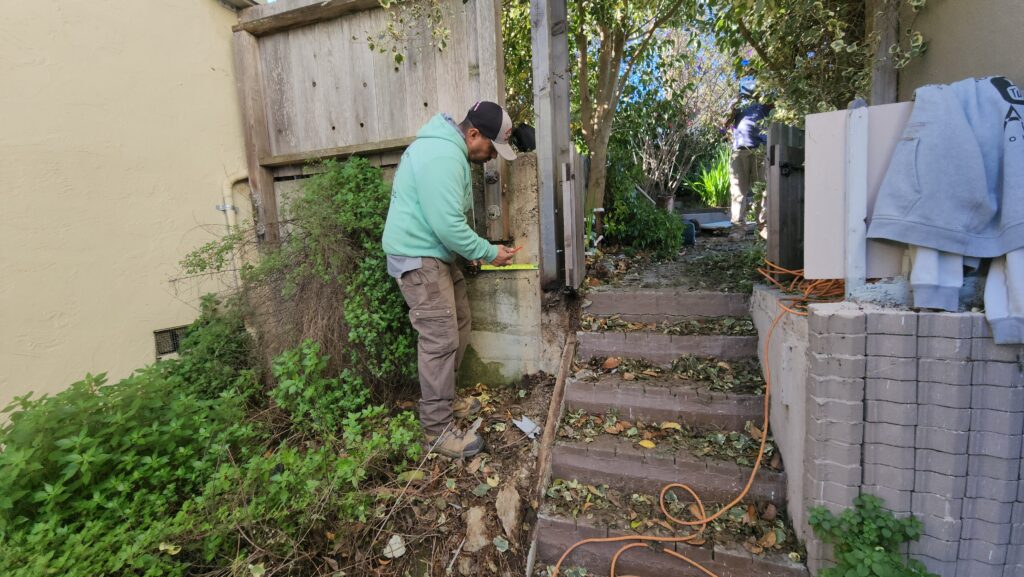 All Access Construction photo of the original failing concrete steps on a Belmont hillside before demolition, showing cracked treads and uneven risers.