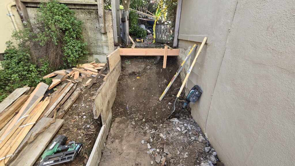 All Access Construction view of the old Belmont hillside staircase prior to demo, showing worn-out steps running alongside the house.