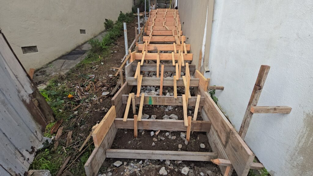 All Access Construction forming new concrete stairs on a Belmont hillside with full step framing.