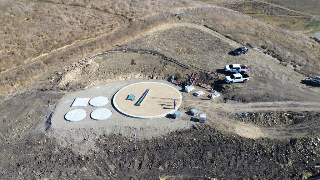 All Access Construction drone view showing compacted tank pad and concrete access pads during Milpitas water tank project