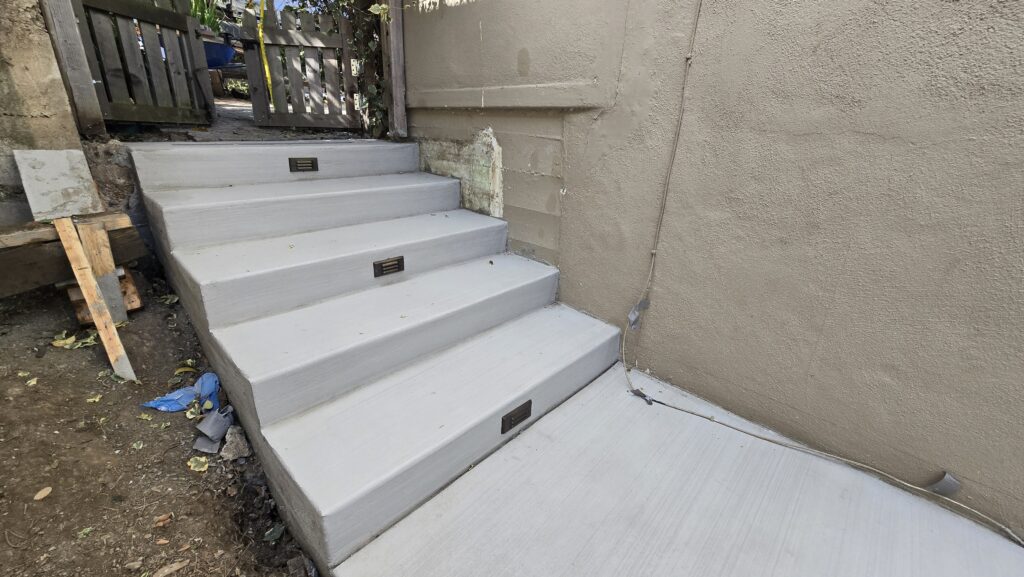 Finished Belmont hillside concrete stairs with integrated LED step lighting by All Access Construction.