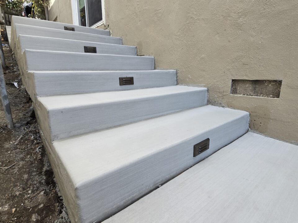 Finished Belmont concrete staircase with Alliance step lights installed by All Access Construction.