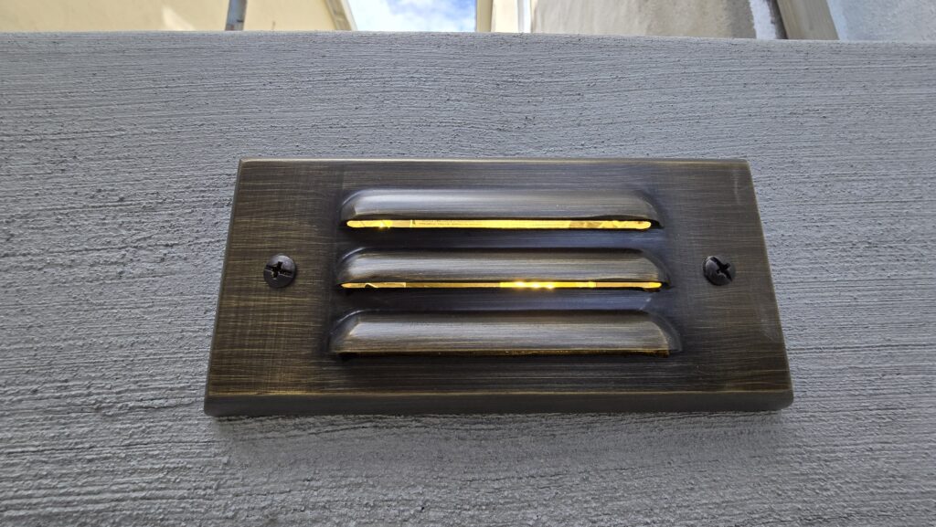 Upper landing of Belmont concrete steps with built-in Alliance step light by All Access Construction.