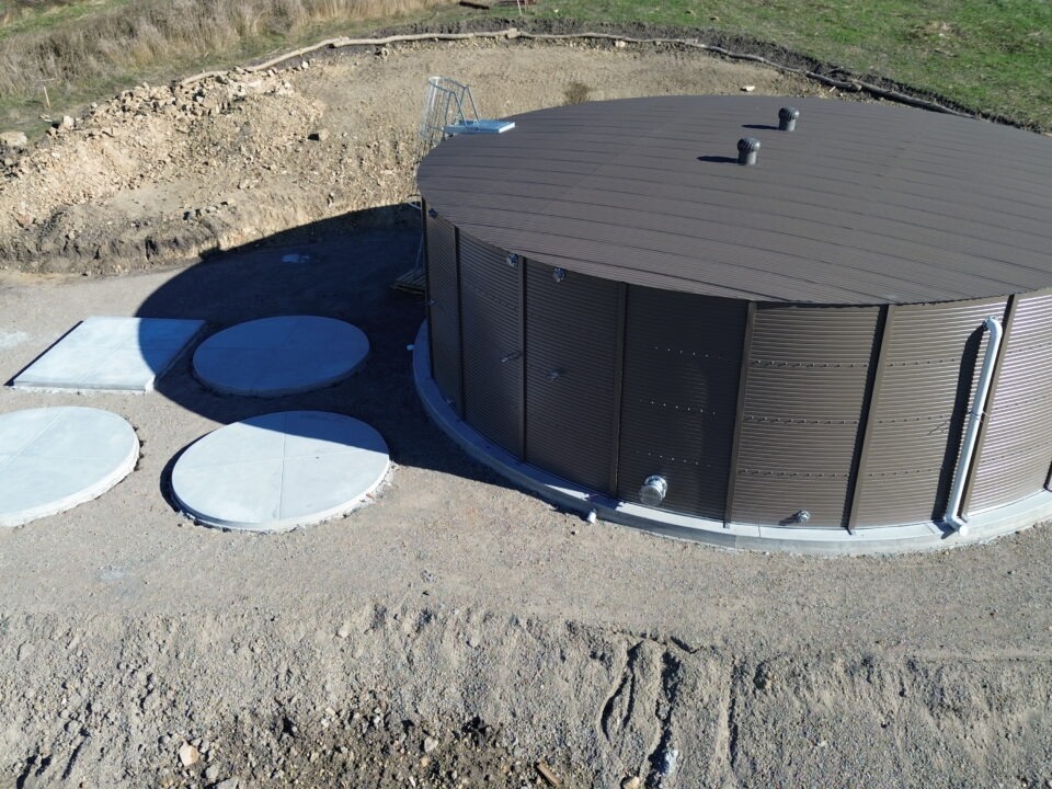 All Access Construction Milpitas water tank close-up showing finished concrete base and surrounding concrete access pads
