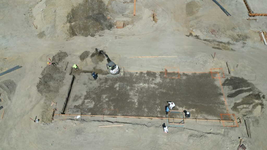 Drone photo of All Access Construction excavating and compacting the carport slab foundation in Milpitas, California.