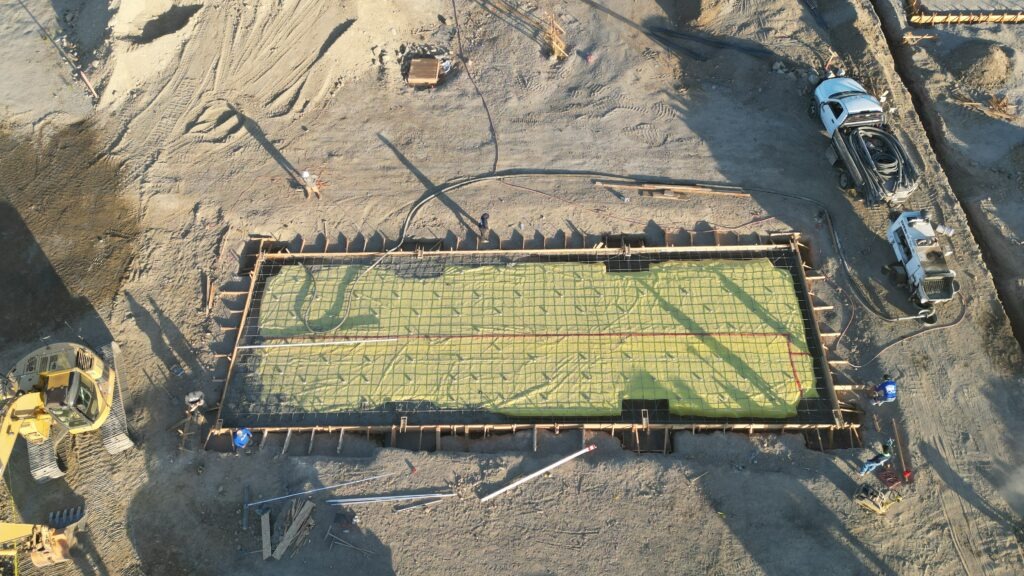 Drone image of All Access Construction installing rebar and a vapor barrier for the concrete carport slab in Milpitas, Santa Clara County.