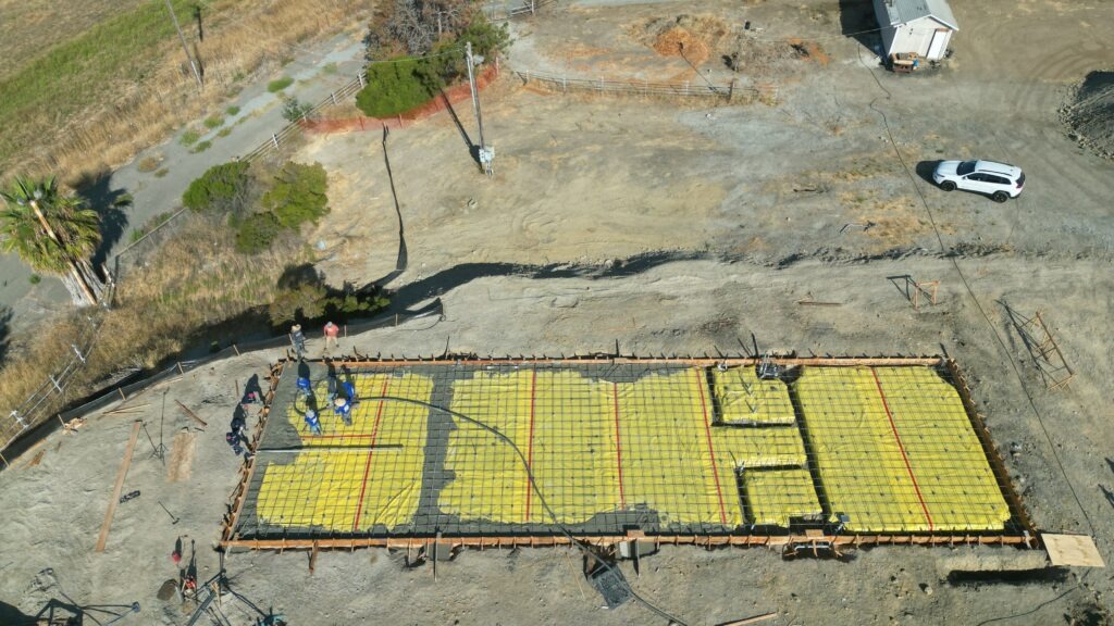 All Access Construction installing rebar grid and vapor barrier for agricultural shed concrete slab foundation.