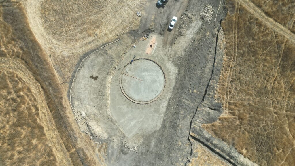All Access Construction crew setting elevations and forms for 50-foot circular tank footprint Milpitas