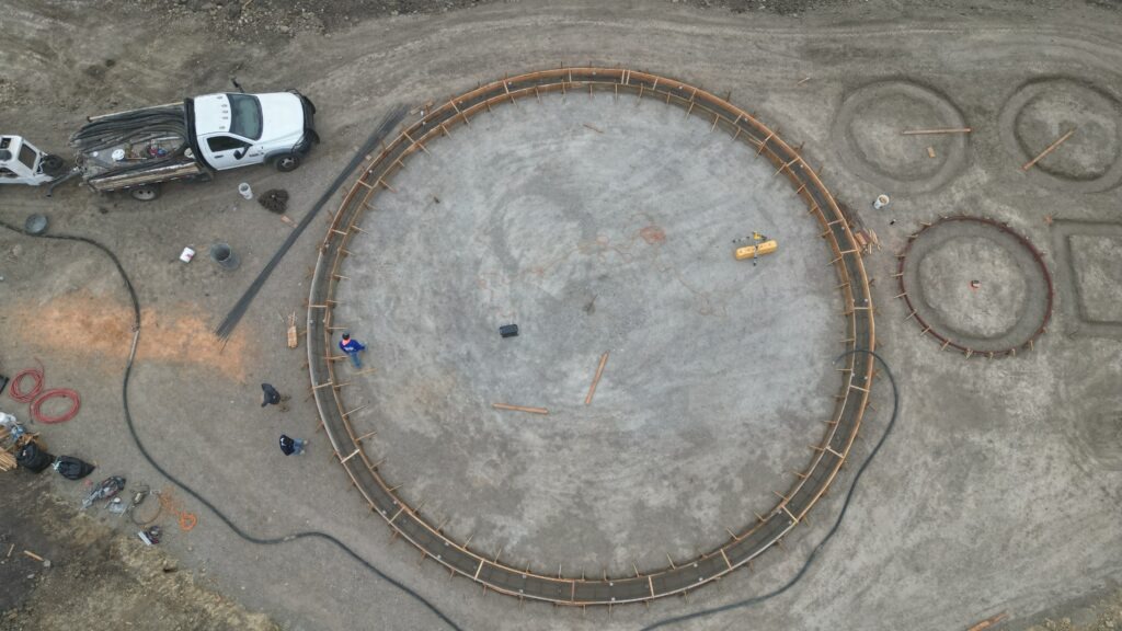 All Access Construction overhead drone view shaping circular water tank foundation in Milpitas hills