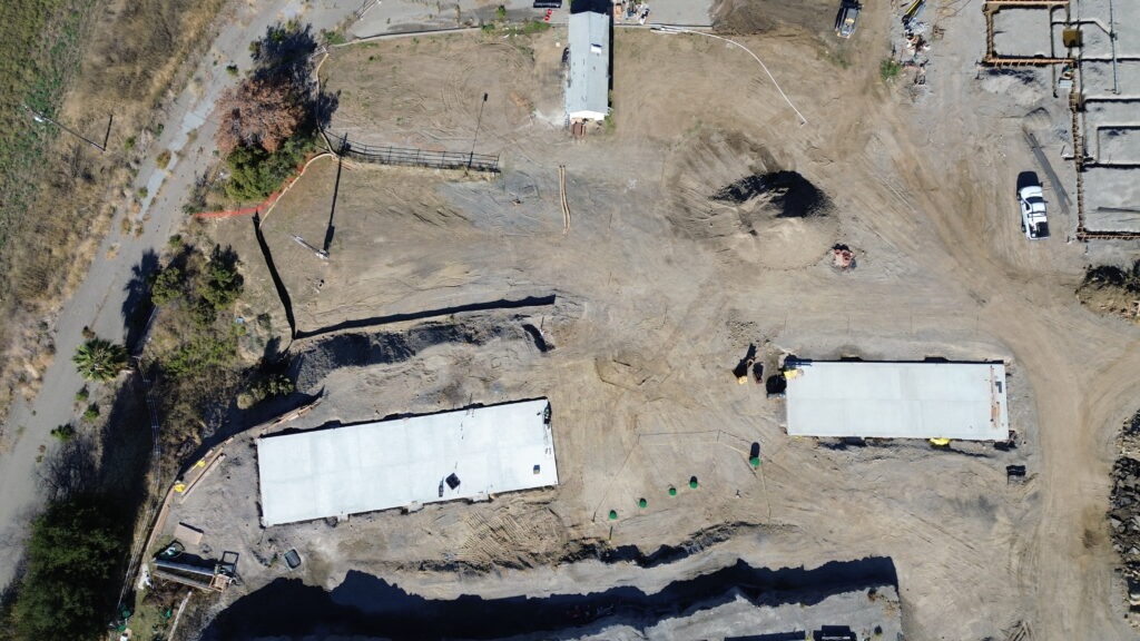 All Access Construction long concrete foundation slab built for agricultural shed installation, drone top-down view.
