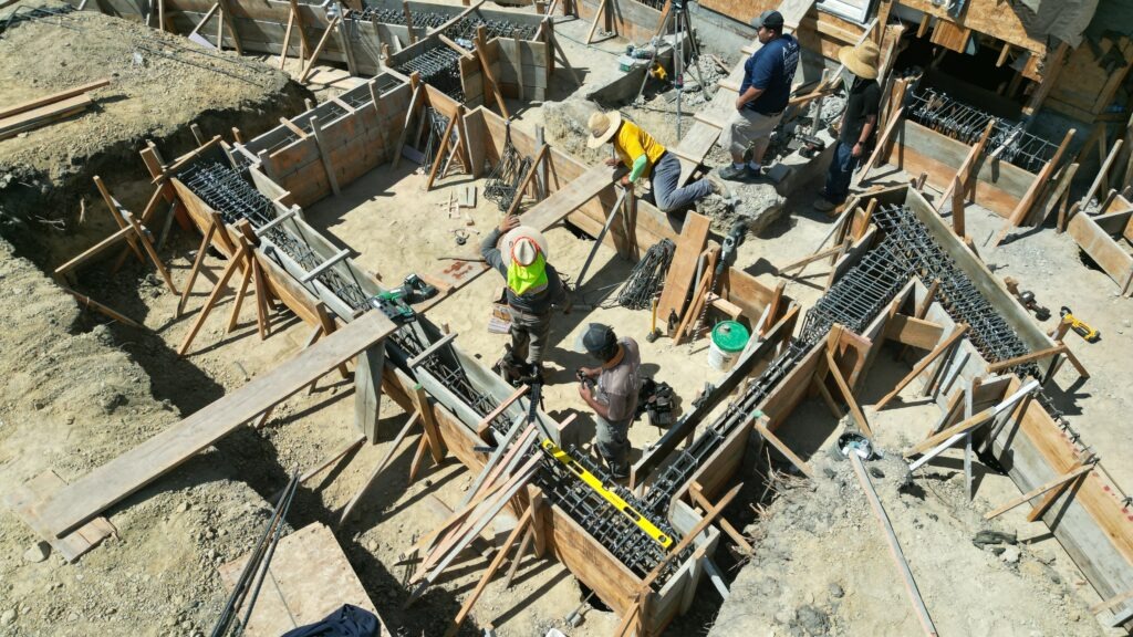 Milpitas structural concrete grade beam layout with heavy rebar installation for hillside foundation, All Access Construction.