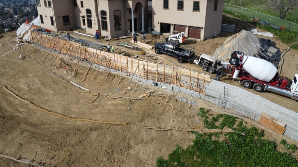 Wood formwork and tie placement for ten inch thick concrete retaining wall in Milpitas California