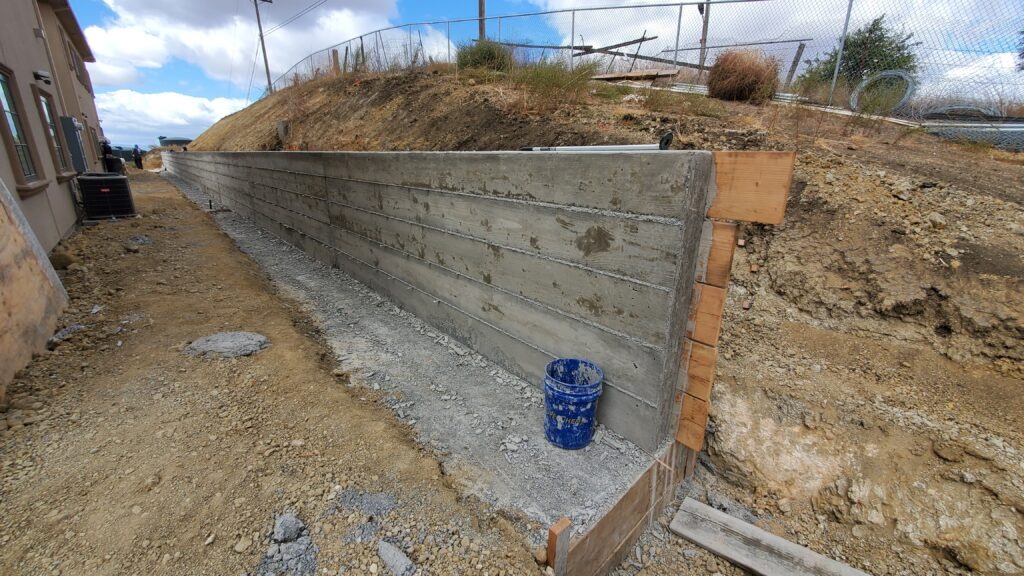 Completed concrete retaining wall end view in Milpitas California Santa Clara County measuring 160 feet long and 5 feet high