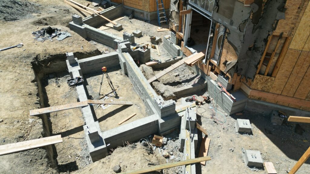 Finished concrete grade beam sections and structural foundation wall layout for Milpitas rebuild