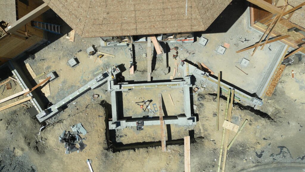Overhead drone view of completed grade beam and pier foundation layout during Milpitas structural rebuild