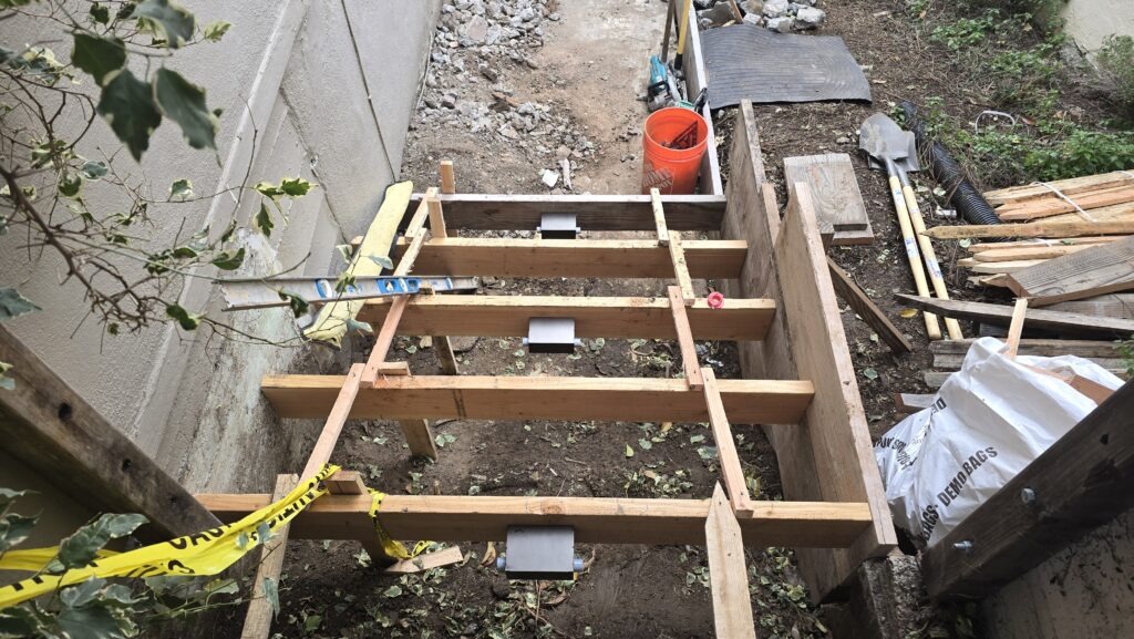 All Access Construction – framing new Belmont concrete stairs with step lighting boxes installed