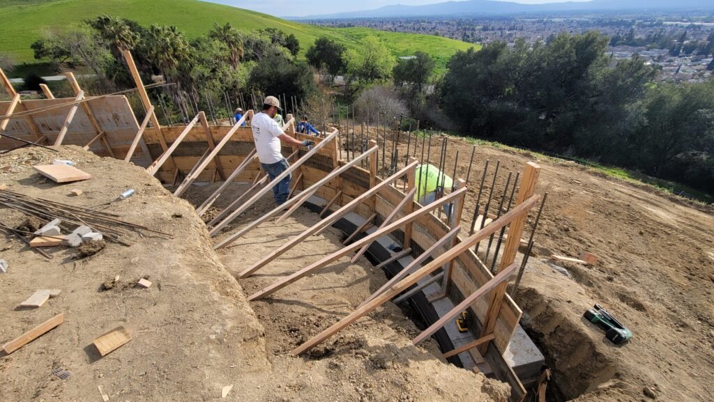 Formwork and rebar setup for a 6 foot tall curved concrete retaining wall in Milpitas California Santa Clara County