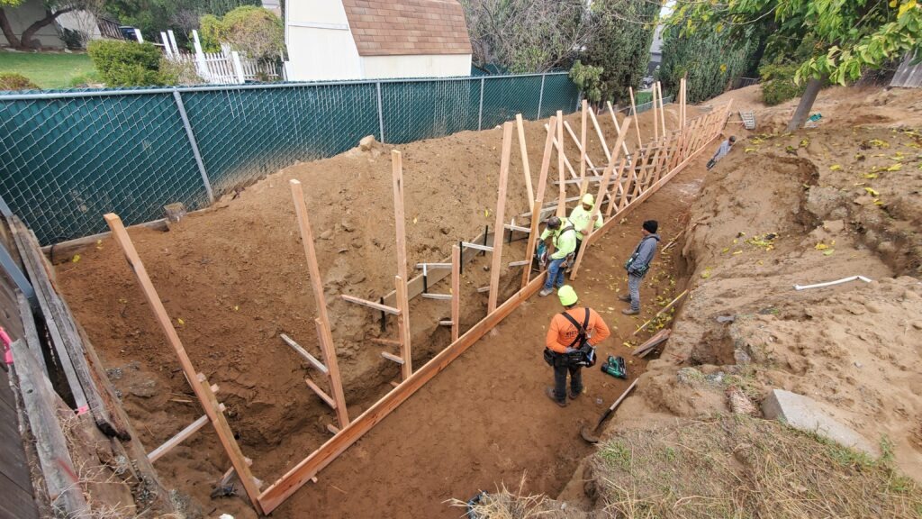 Wood retaining wall form panels fully installed on steep slope in Oakley California Contra Costa County
