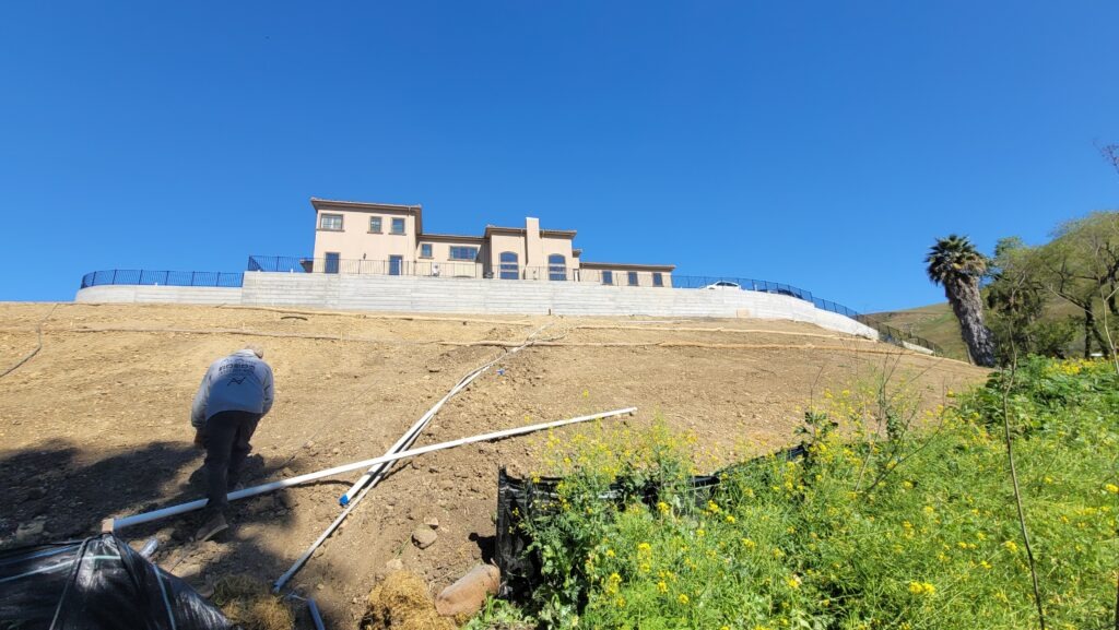 Overhead drone shot showing full length of concrete retaining wall project in Milpitas California