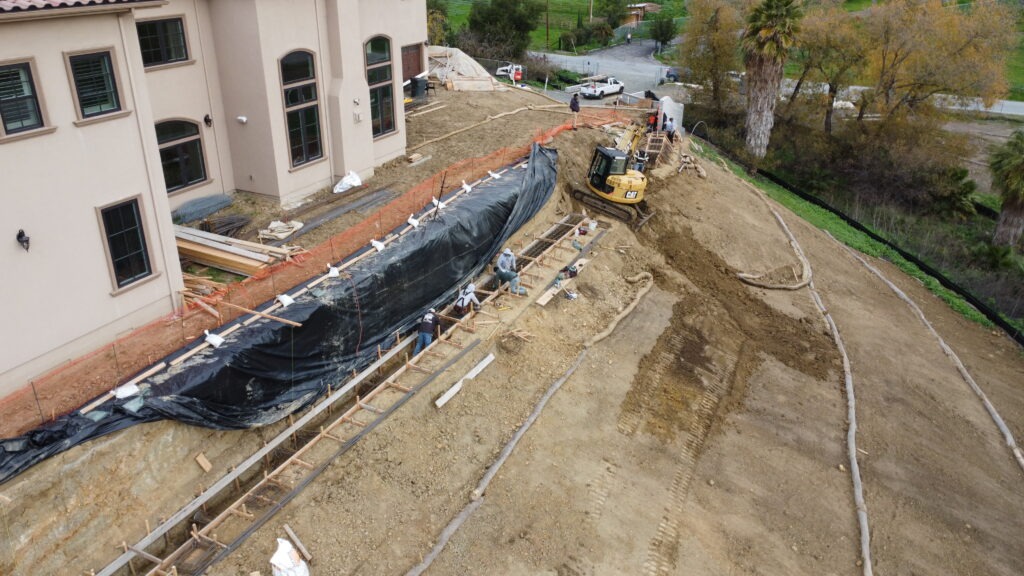 Concrete grade beam rebar installation drone shot in Milpitas CA showing structural reinforcement layout