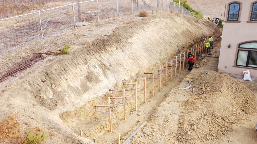 Concrete retaining wall formwork installation in a narrow side yard in Milpitas California Santa Clara County