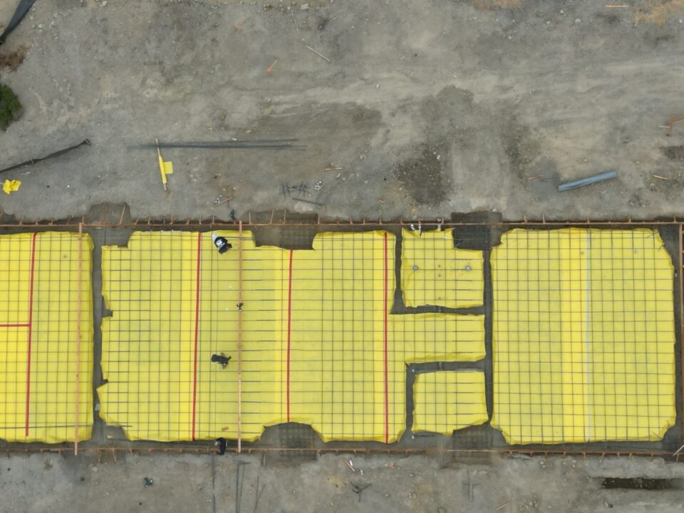 Drone view of Milpitas AG shed slab prep with vapor barrier and rebar