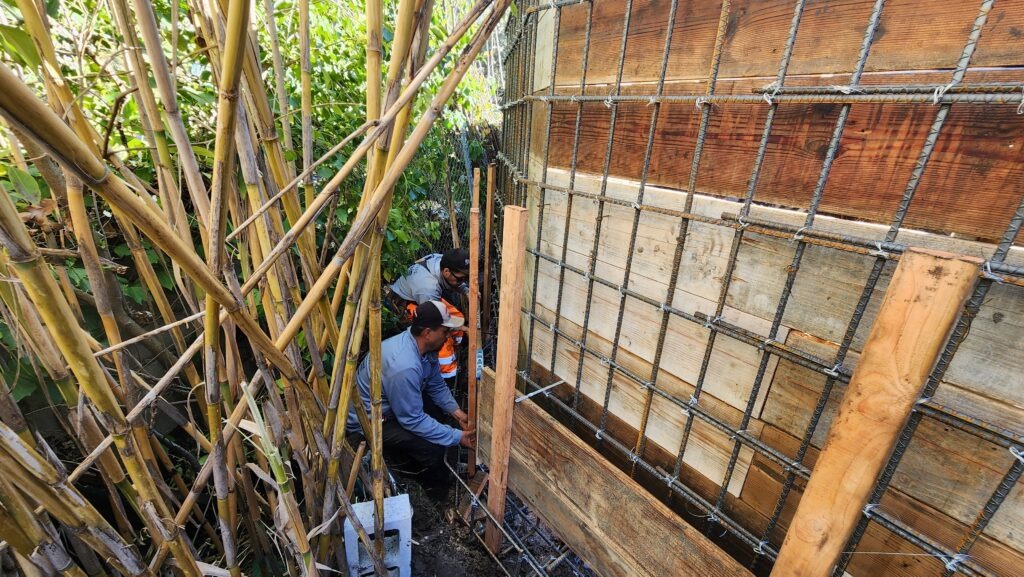 Rebar cage installation for structural retaining wall in Walnut Creek hillside with tight access conditions