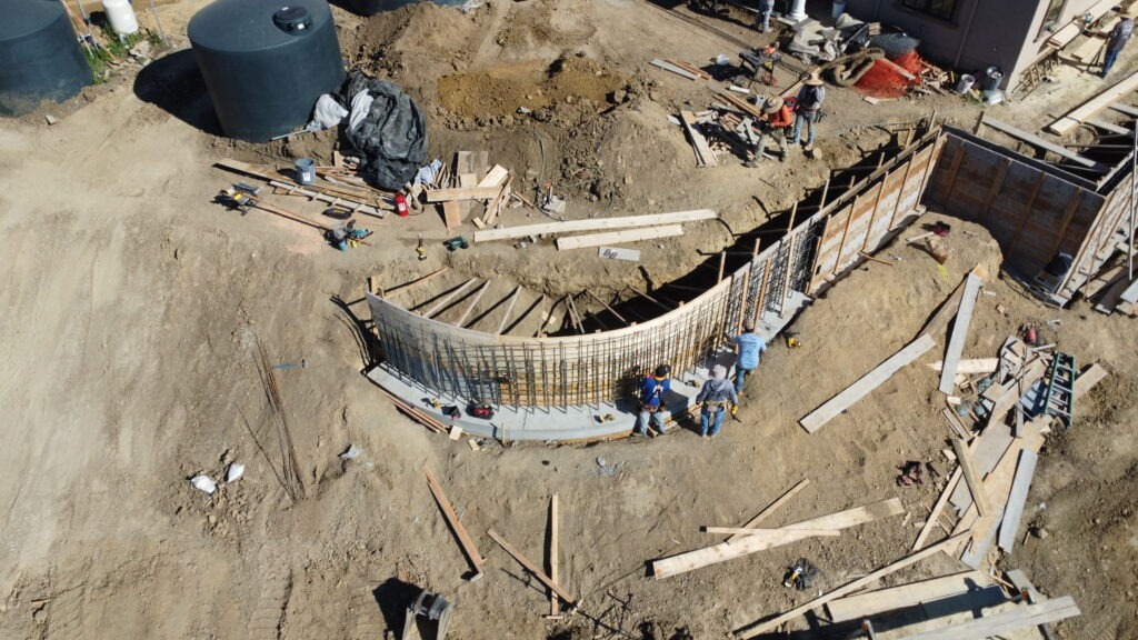 Aerial drone shot showing progress of 50 foot long curved retaining wall in Milpitas CA near San Jose