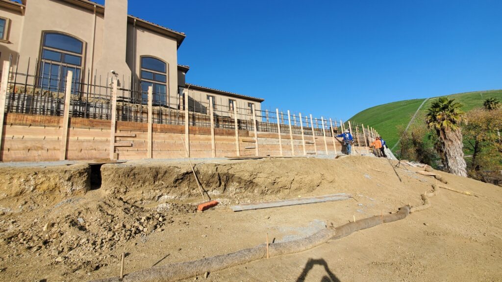 Concrete retaining wall formwork installation for seven foot tall structural wall in Milpitas California