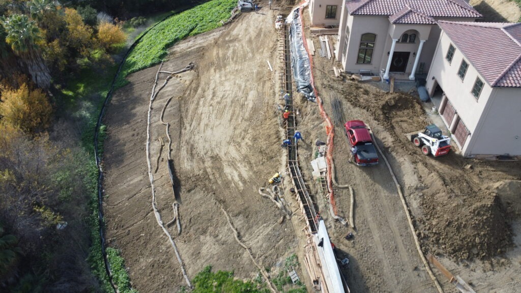 Hillside concrete grade beam drone photo in Milpitas California showing structural foundation work on slope