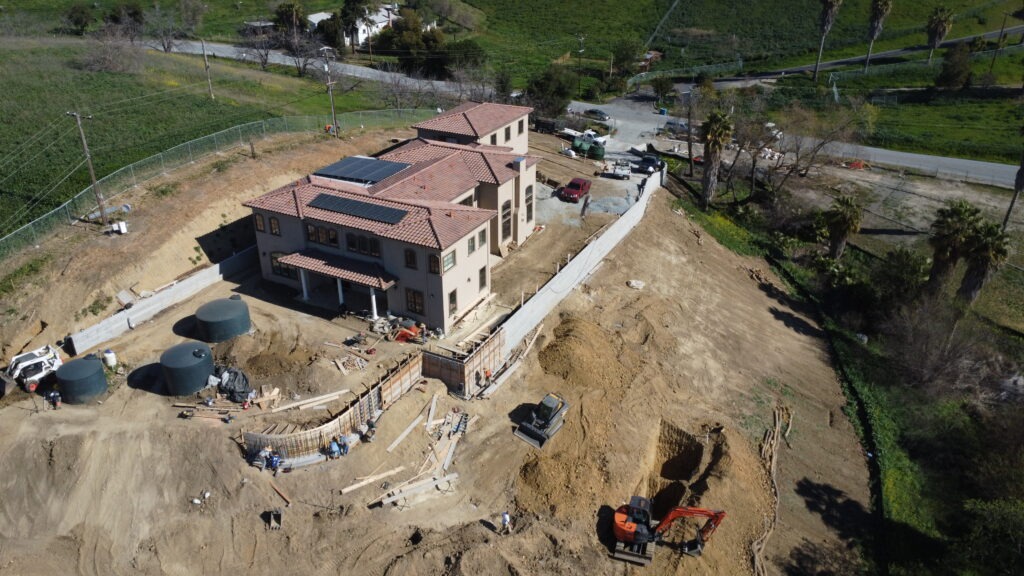 Aerial drone shot showing progress of 50 foot long curved retaining wall in Milpitas CA near San Jose