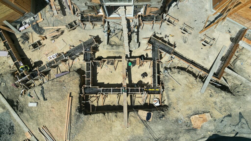 Drone view of heavy rebar framing and forming for structural grade beam foundation in Milpitas