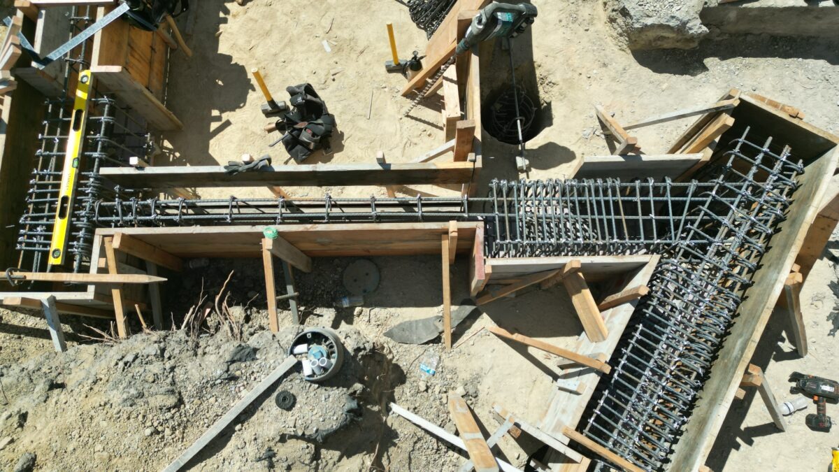 Aerial drone image of Milpitas South Bay hillside showing steep terrain where structural concrete piers and grade beams are required.