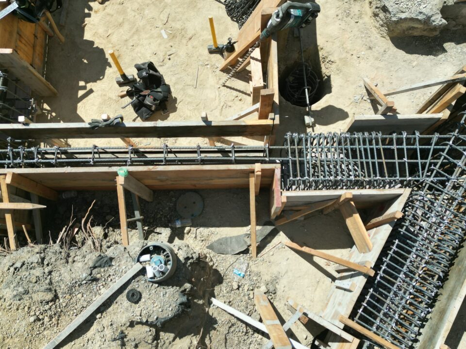 Aerial drone image of Milpitas South Bay hillside showing steep terrain where structural concrete piers and grade beams are required.